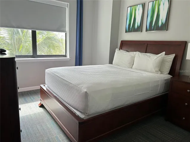 a bedroom with a bed and a mirror