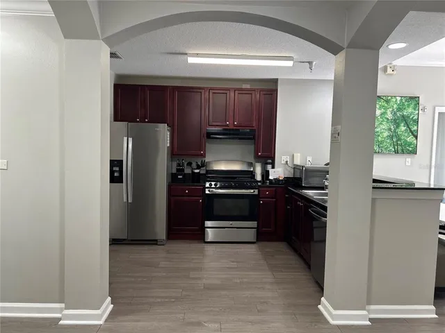 a kitchen with a refrigerator stove and sink