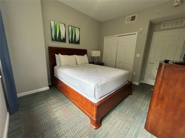 a bedroom with a bed and a mirror