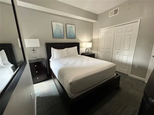 a bedroom with a bed gym equipment and a window