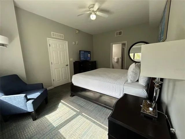 a bed sitting in a bedroom next to a window