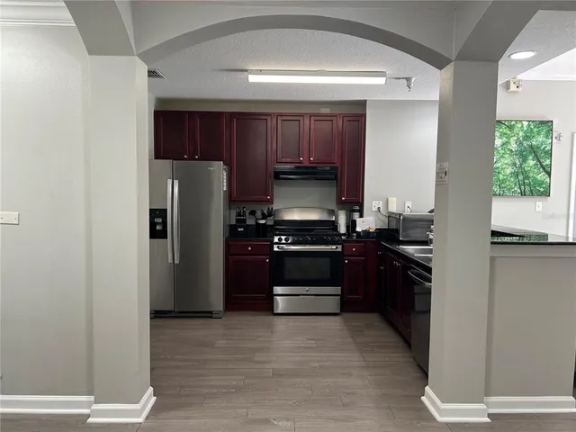 a kitchen with a refrigerator stove and a sink