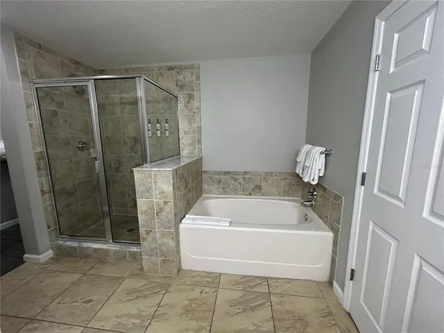 a living room with furniture fireplace and a large window