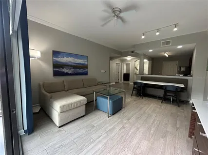a living room with furniture and a large mirror