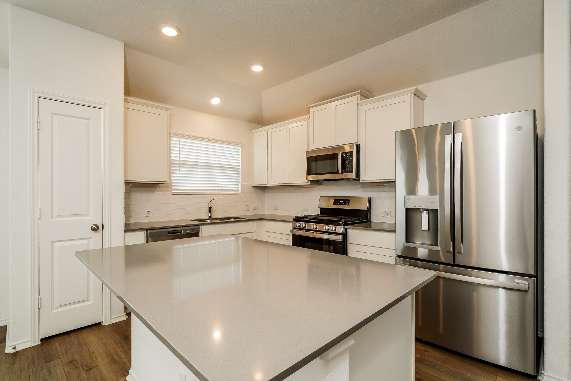 341 Madrid Kyle, TX 78640 - Photo 9 of 27 Culinary aspirations come alive in this pristine kitchen, featuring modern appliances and abundant counter space.