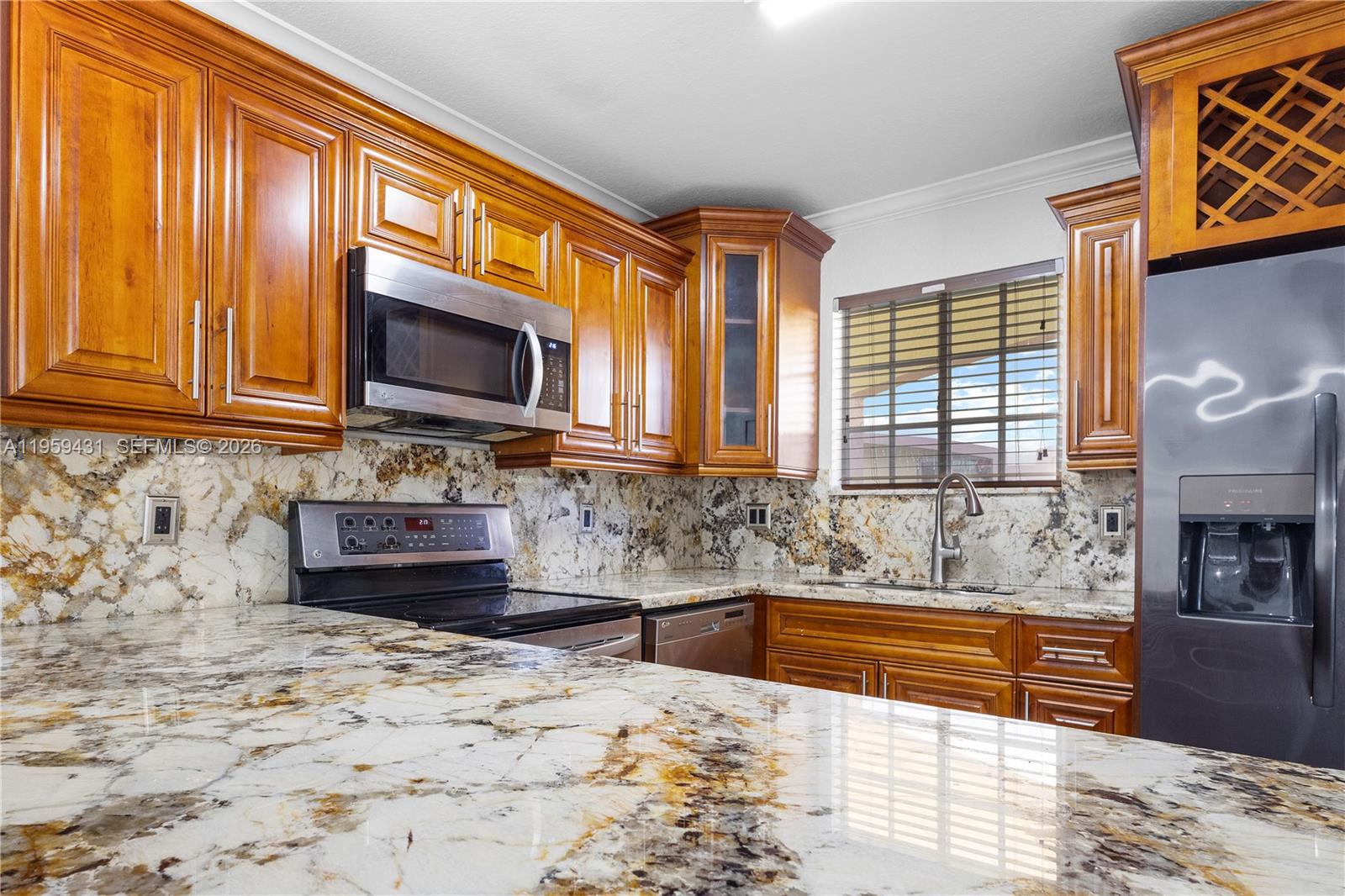 a kitchen with stainless steel appliances microwave stove and refrigerator