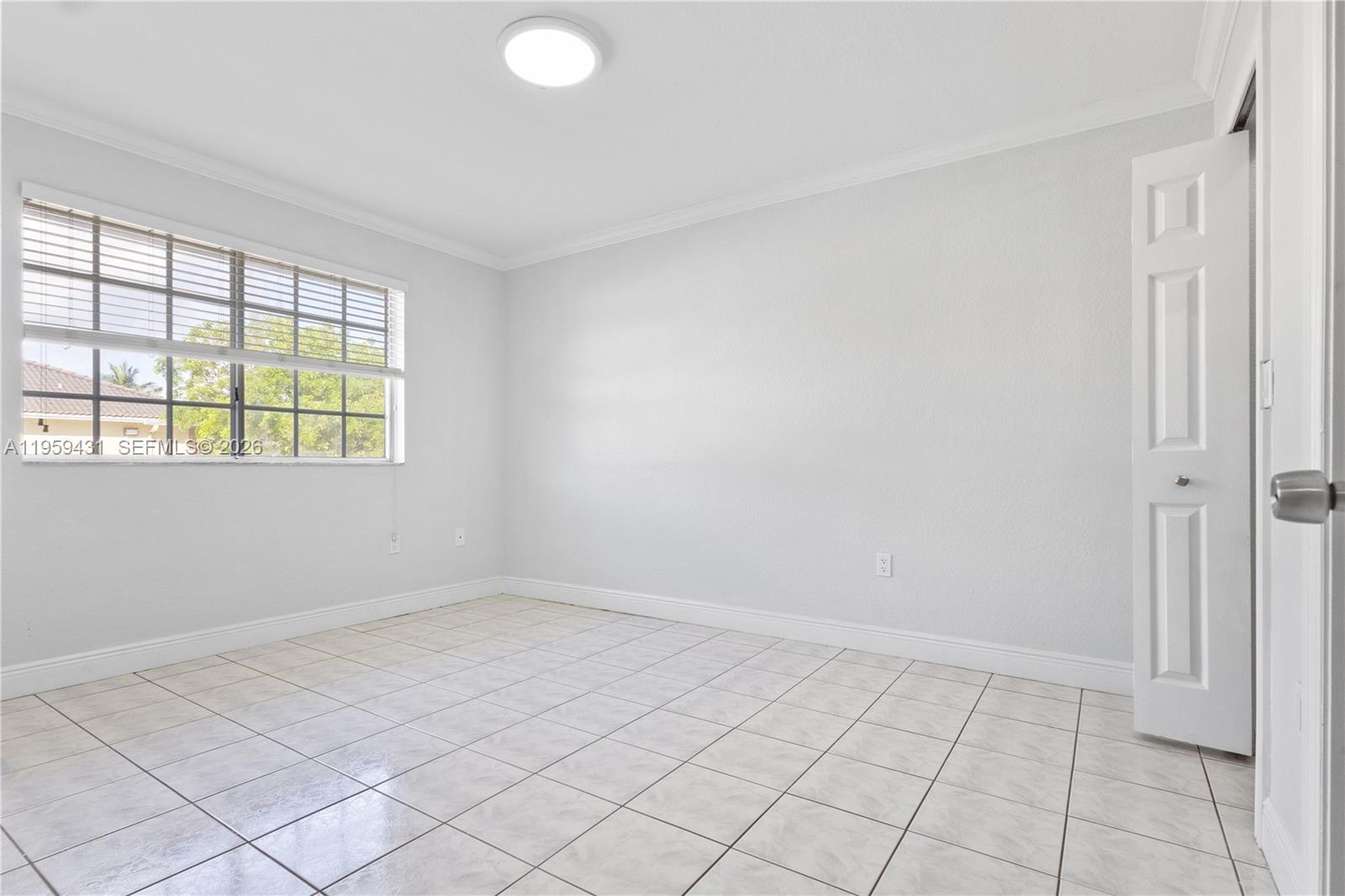 6765 Northwest 182nd Street, Unit 104 Hialeah, FL 33015 - Photo 11 of 24 an empty room with windows