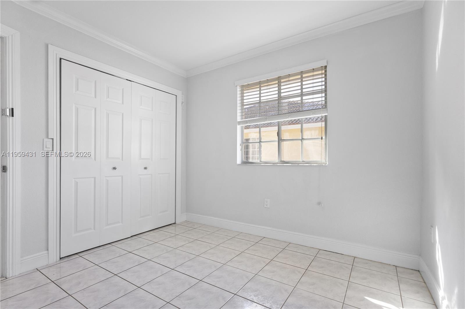 6765 Northwest 182nd Street, Unit 104 Hialeah, FL 33015 - Photo 17 of 24 a view of an empty room with window