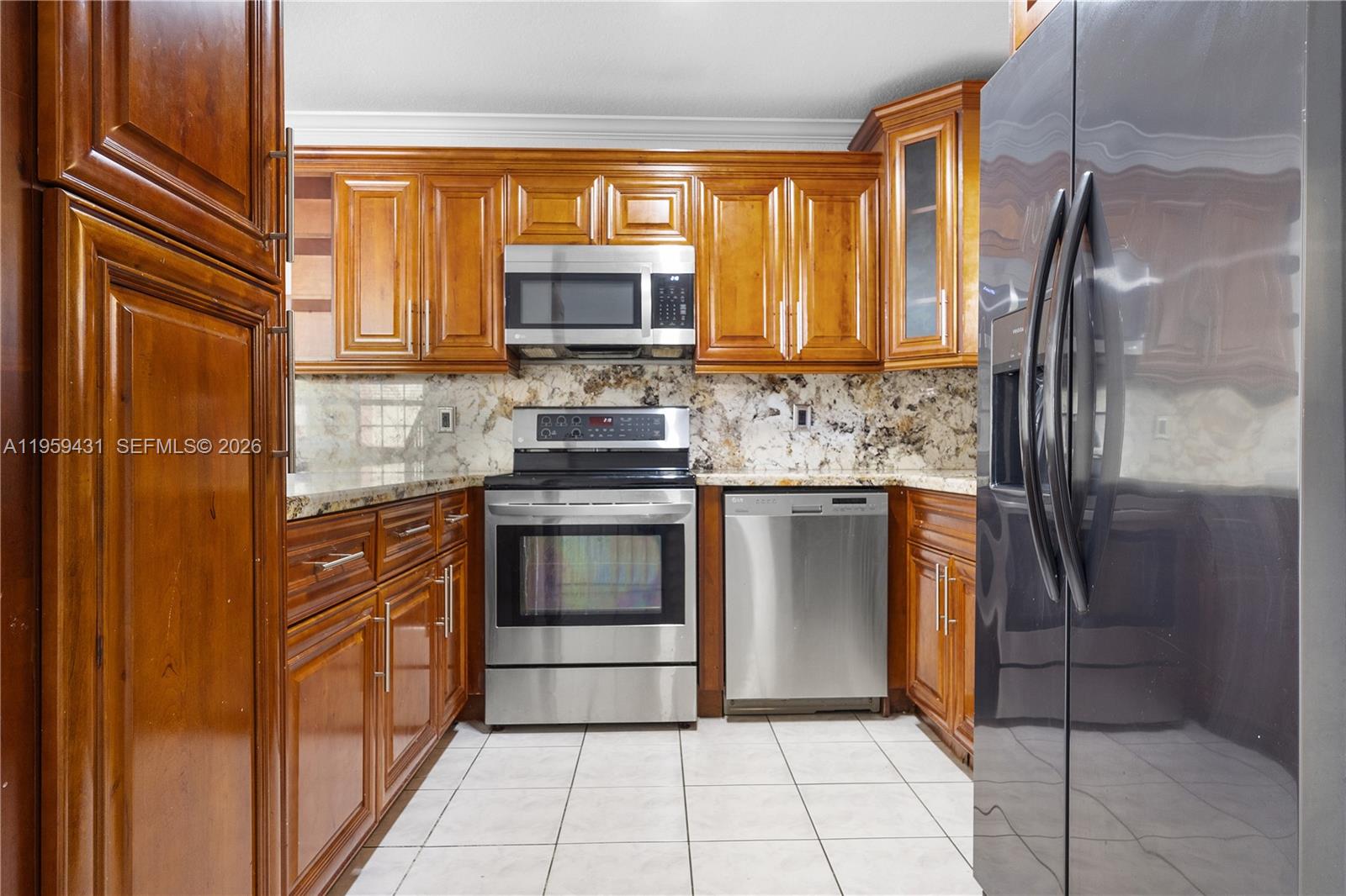 6765 Northwest 182nd Street, Unit 104 Hialeah, FL 33015 - Photo 2 of 24 a kitchen with stainless steel appliances granite countertop a refrigerator and a sink
