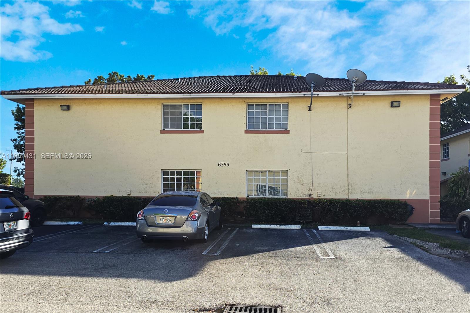 6765 Northwest 182nd Street, Unit 104 Hialeah, FL 33015 - Photo 24 of 24 a front view of a house with a yard