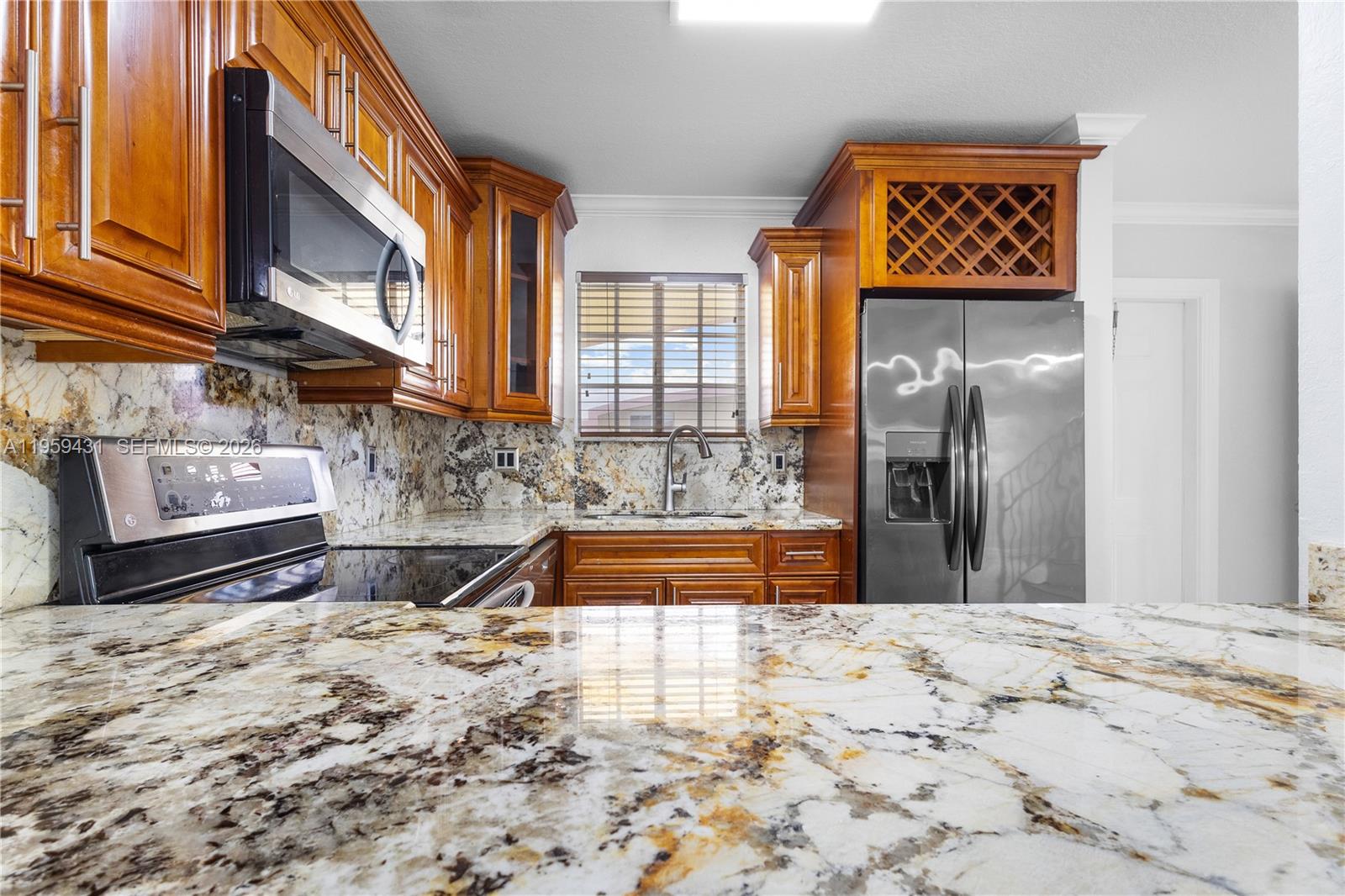 6765 Northwest 182nd Street, Unit 104 Hialeah, FL 33015 - Photo 4 of 24 a bathroom with a granite countertop sink and a bathtub