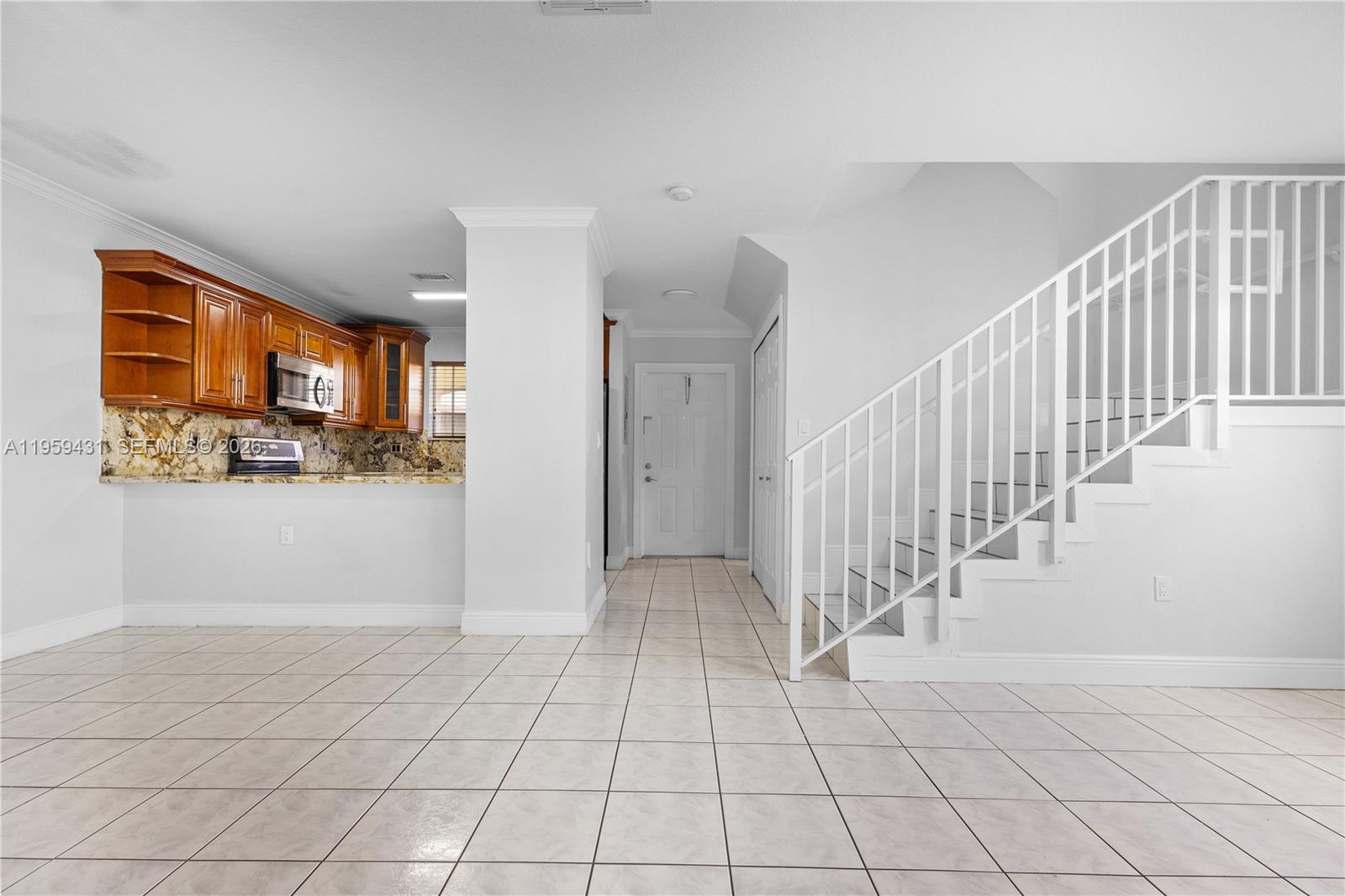 6765 Northwest 182nd Street, Unit 104 Hialeah, FL 33015 - Photo 5 of 24 a view of an entryway with wooden floor