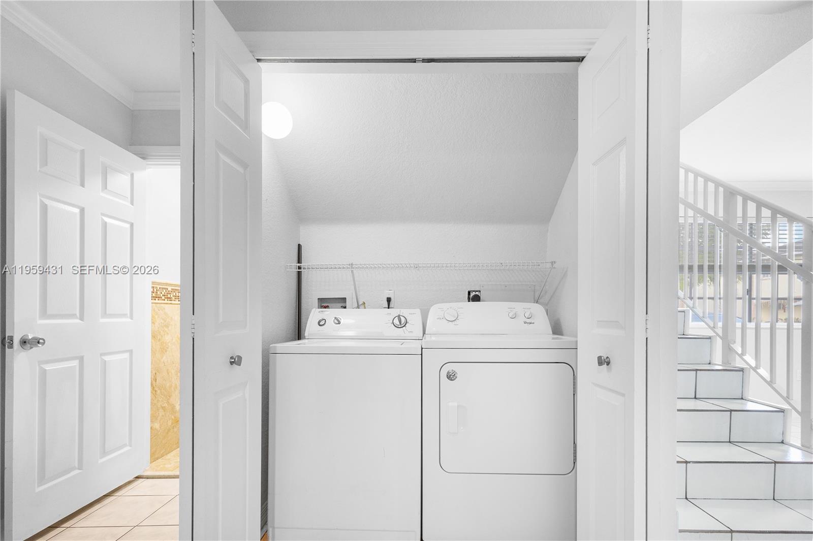 6765 Northwest 182nd Street, Unit 104 Hialeah, FL 33015 - Photo 7 of 24 a utility room with dryer and washer