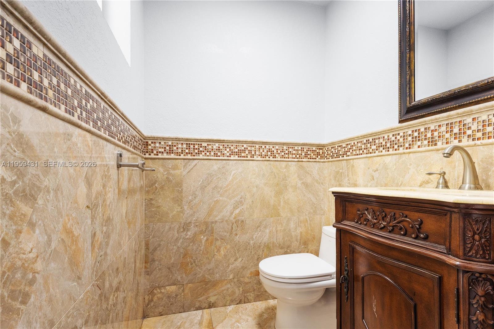 6765 Northwest 182nd Street, Unit 104 Hialeah, FL 33015 - Photo 9 of 24 a bathroom with a toilet and a shower curtain