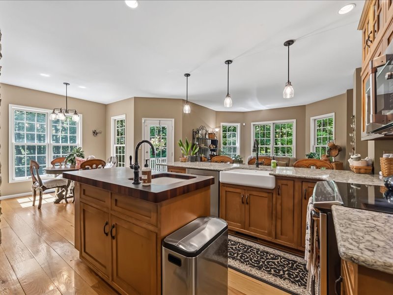 1168 Mt Pleasant Road Bangor, PA 18013 - Photo 33 of 100 Gleaming hardwood floors and stone countertops anchor this open kitchen flowing into a dining area.