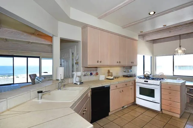 a kitchen with a sink stove and cabinets