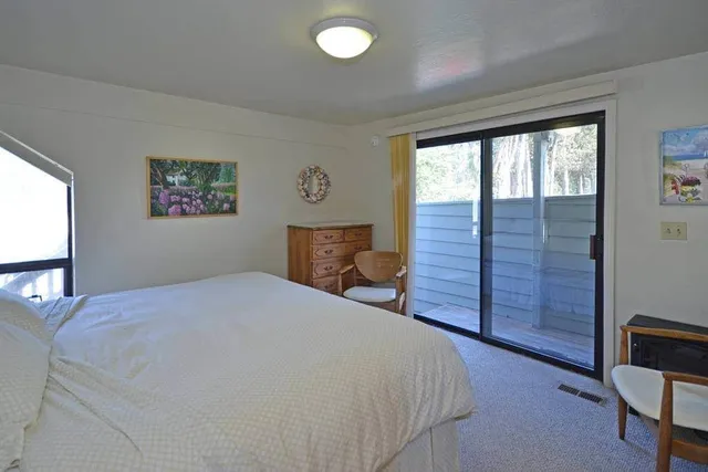a bedroom with a bed and a bookshelf
