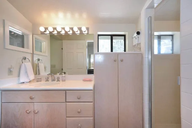 a bathroom with a sink double vanity and a mirror
