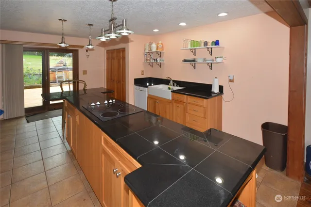 a kitchen with stainless steel appliances granite countertop a stove a sink a refrigerator and a microwave