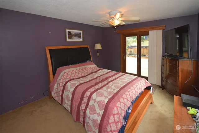 a bedroom with bed and window