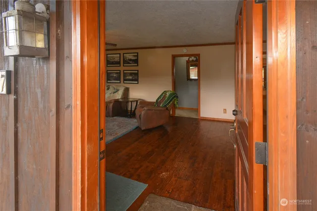 a view of an entryway with wooden floor