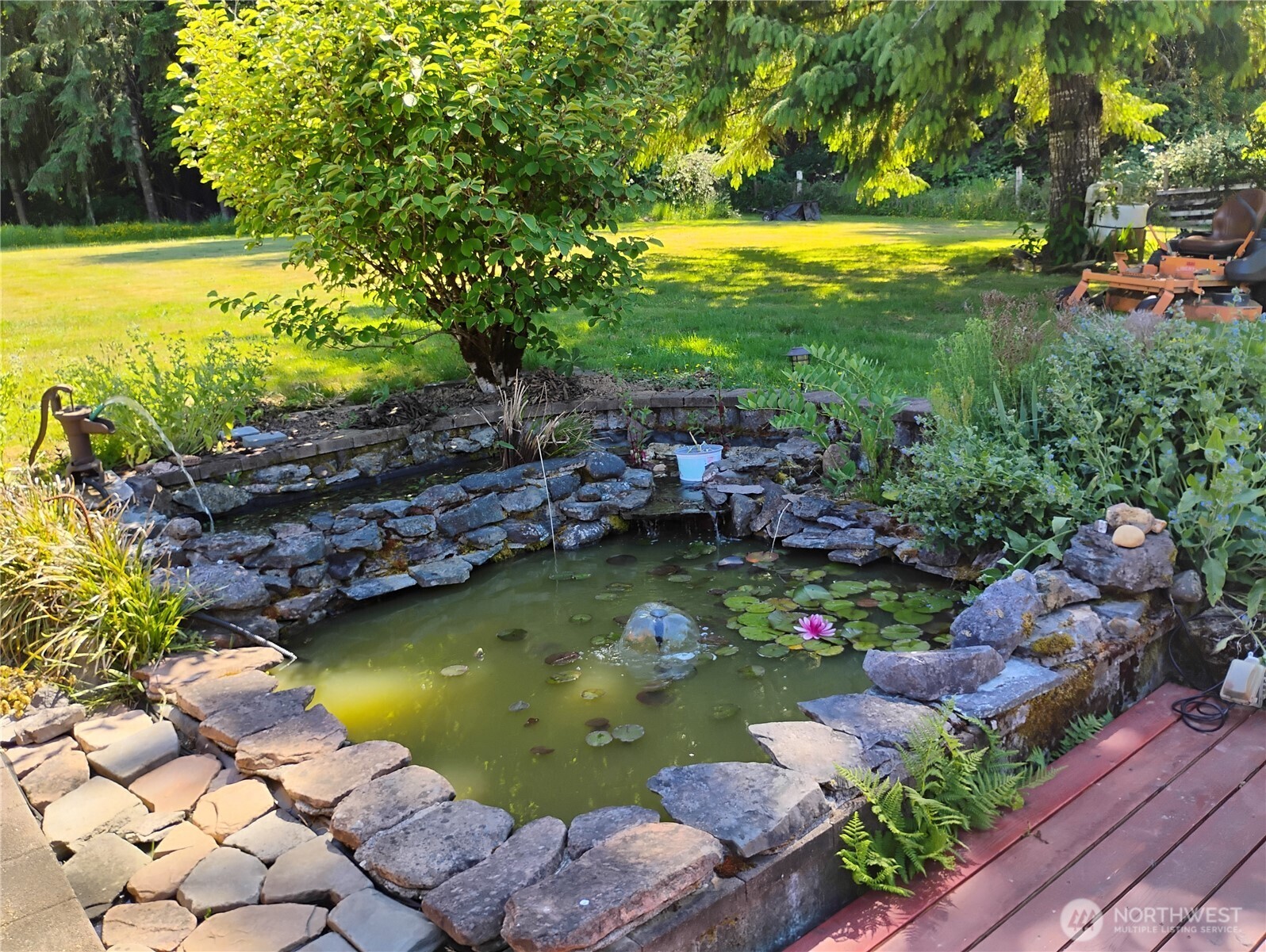 307 Lost Valley Road Curtis, WA 98538 - Photo 5 of 27 a view of a lake with lawn chairs and large trees