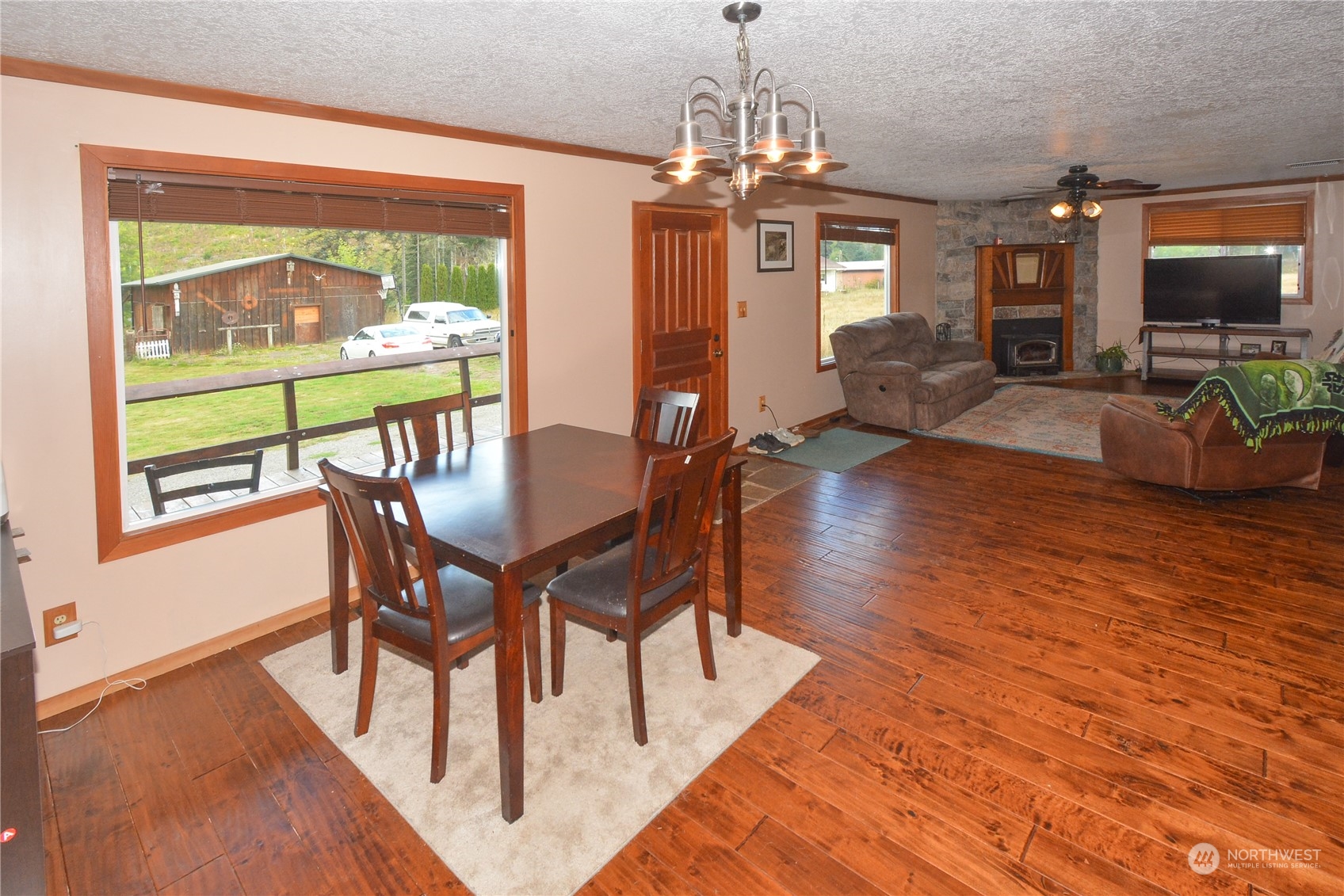 307 Lost Valley Road Curtis, WA 98538 - Photo 9 of 27 a view of a dining room with furniture window and wooden floor
