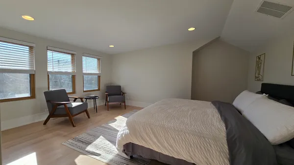 a bedroom with a bed and a chair