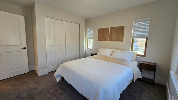 a bedroom with a bed and window