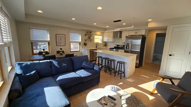 a living room with furniture fireplace and a window