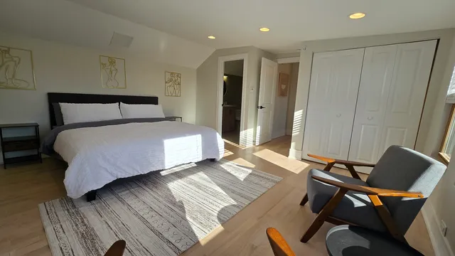 a bedroom with a bed and a chair
