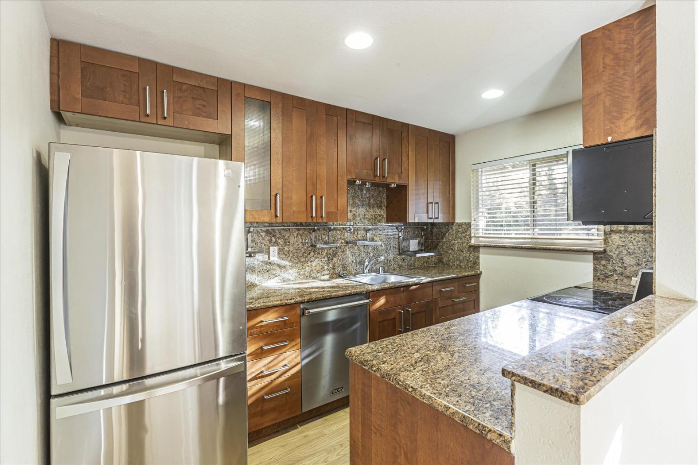 4260 Clayton Road, Unit 20 Concord, CA 94521 - Photo 2 of 35 a kitchen with stainless steel appliances granite countertop a refrigerator a sink dishwasher a stove with wooden cabinets and floor