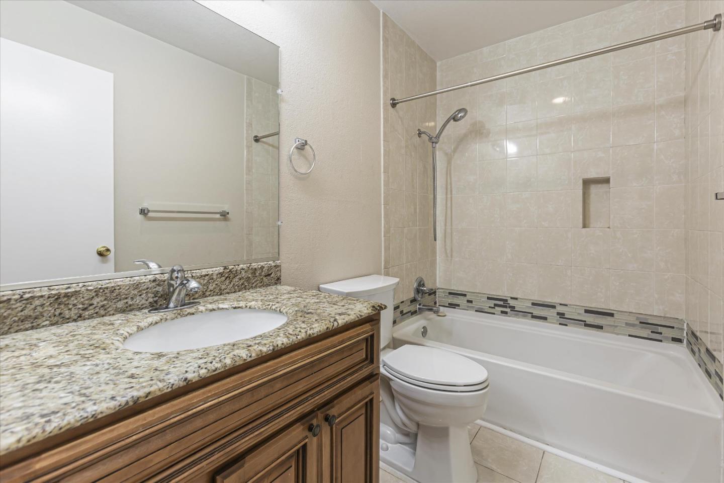 4260 Clayton Road, Unit 20 Concord, CA 94521 - Photo 23 of 35 a bathroom with a granite countertop sink a toilet and a shower