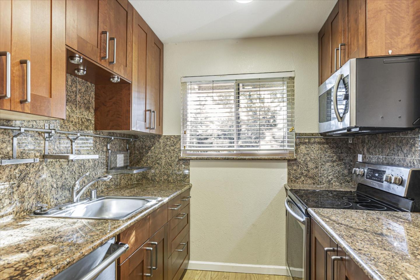 4260 Clayton Road, Unit 20 Concord, CA 94521 - Photo 3 of 35 a kitchen with granite countertop a sink and a stove
