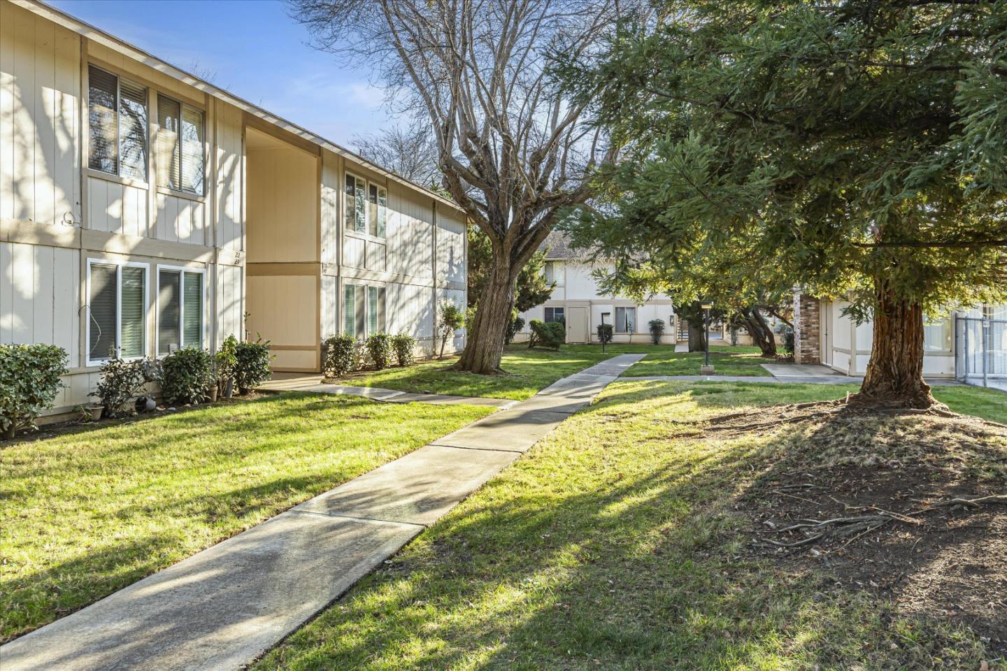4260 Clayton Road, Unit 20 Concord, CA 94521 - Photo 32 of 35 a view of swimming pool with large trees and wooden fence