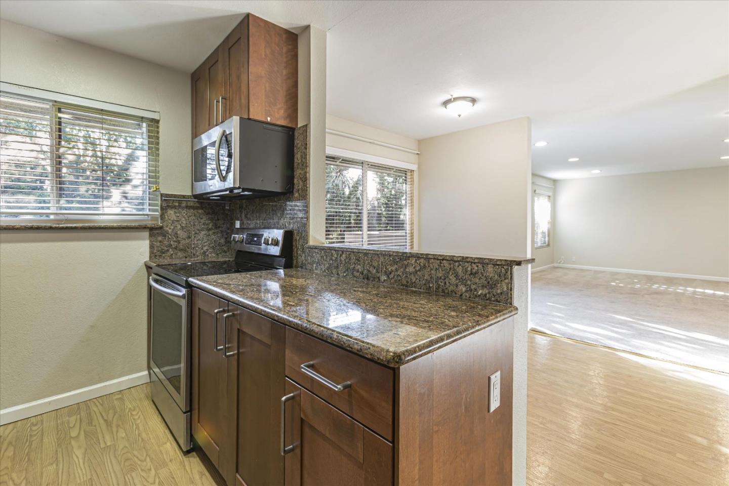 4260 Clayton Road, Unit 20 Concord, CA 94521 - Photo 5 of 35 a kitchen with granite countertop a sink and a stove