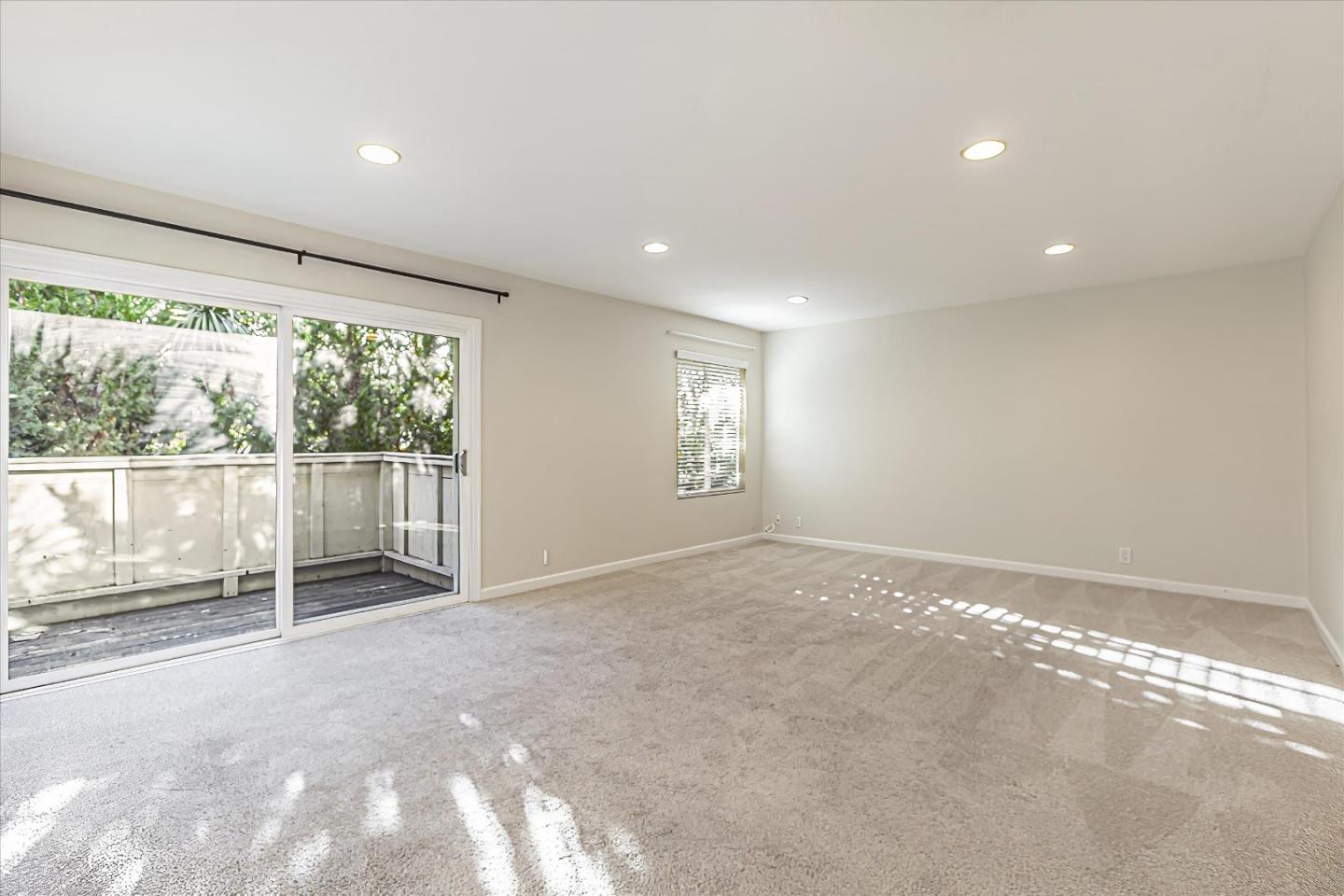 4260 Clayton Road, Unit 20 Concord, CA 94521 - Photo 10 of 35 a view of an empty room with wooden floor and a window