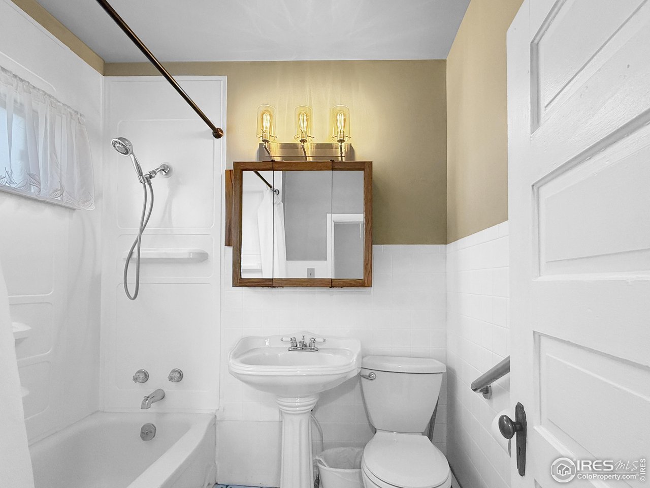 531 Taylor Street Sterling, CO 80751 - Photo 11 of 38 a bathroom with a toilet sink and mirror
