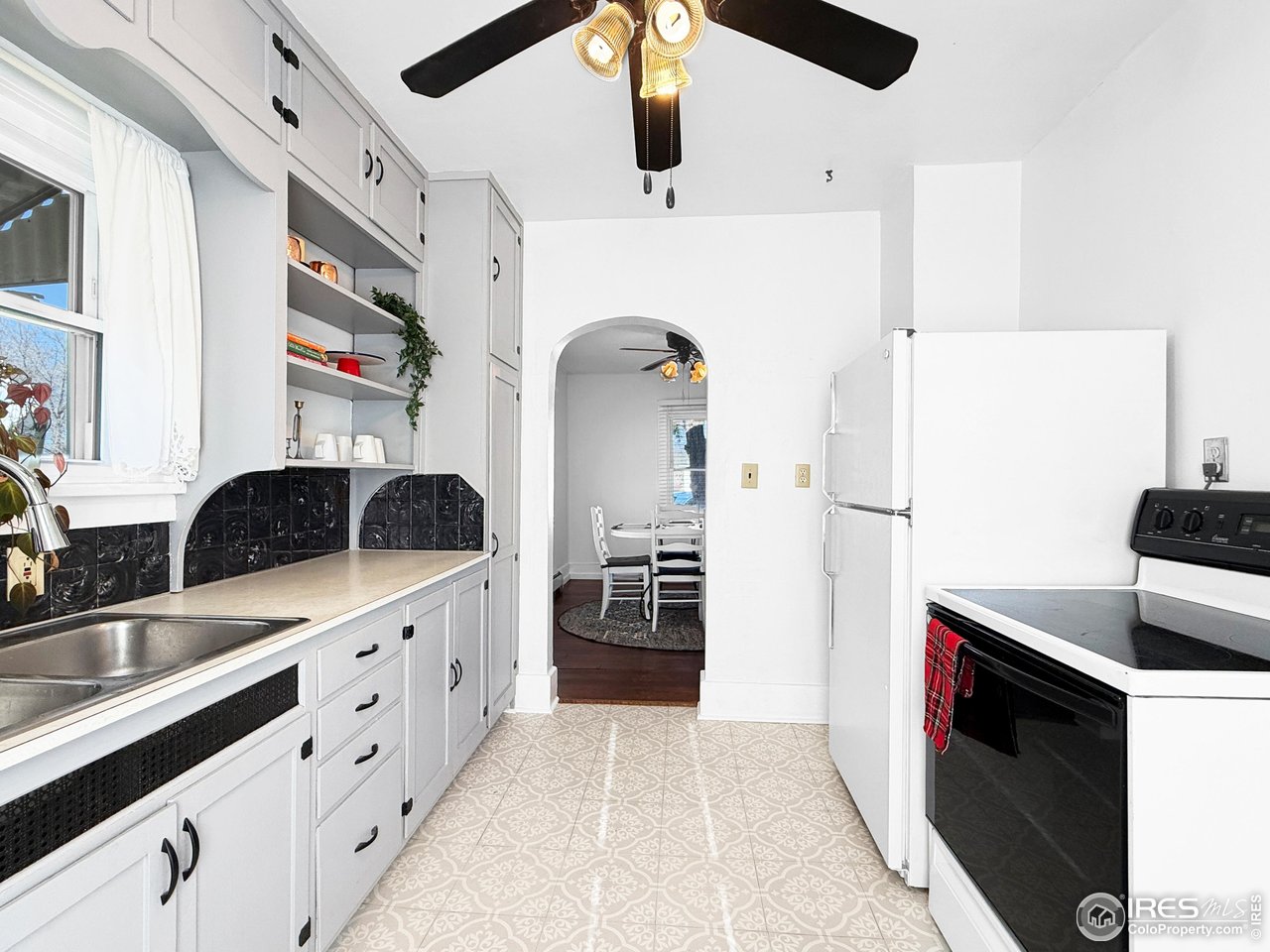 531 Taylor Street Sterling, CO 80751 - Photo 21 of 38 a kitchen with stainless steel appliances a sink a stove and refrigerator