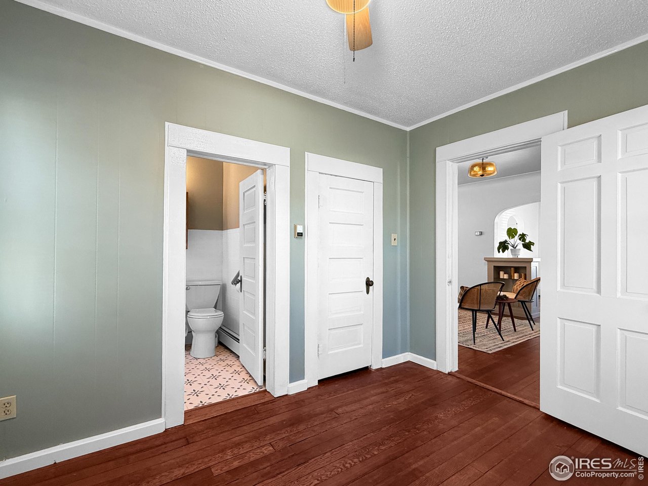 531 Taylor Street Sterling, CO 80751 - Photo 10 of 38 a view of a hallway with wooden floor and a bathroom