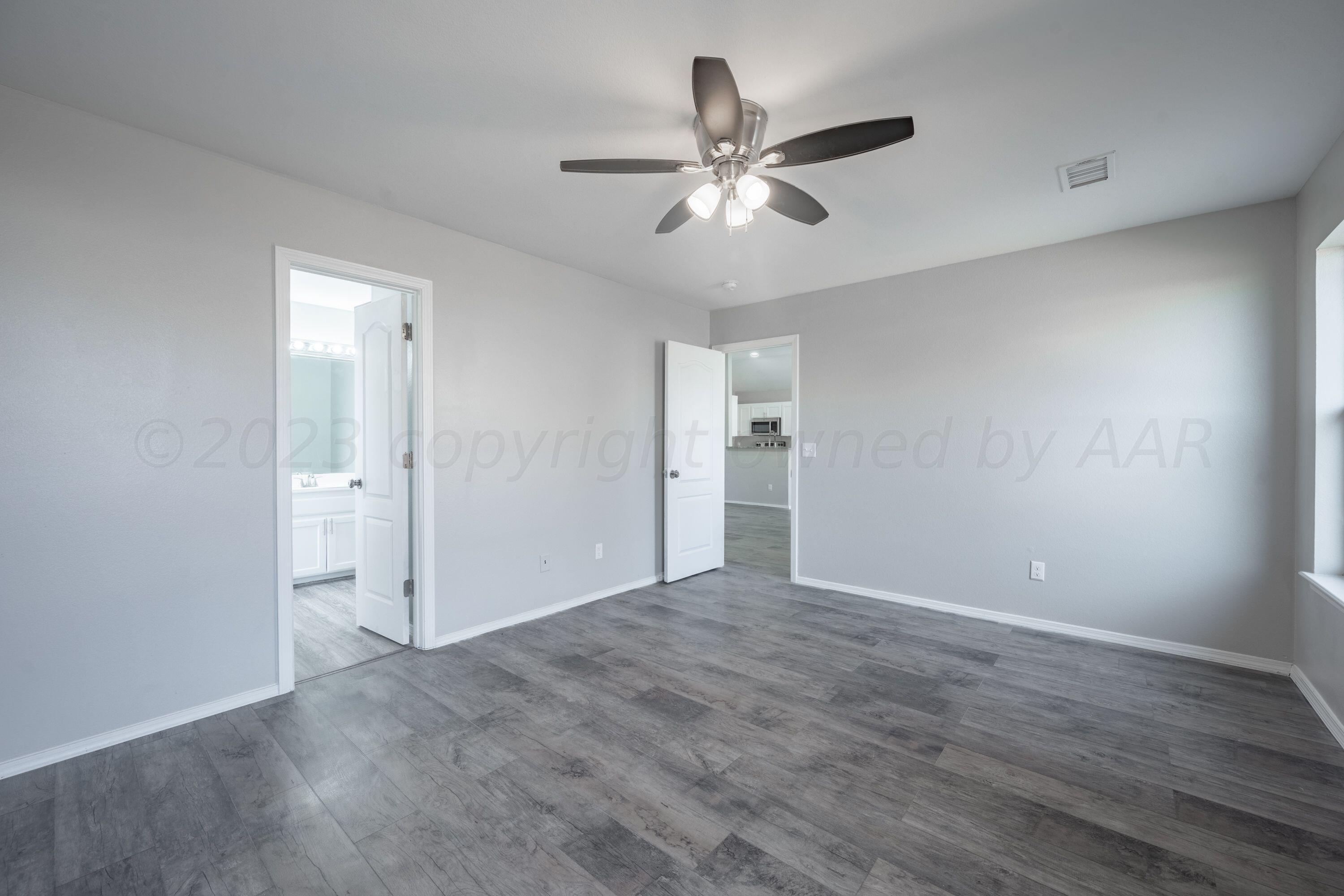 4712 Capulin Lane Amarillo, TX 79110 - Photo 14 of 18 a view of a livingroom with a chandelier fan