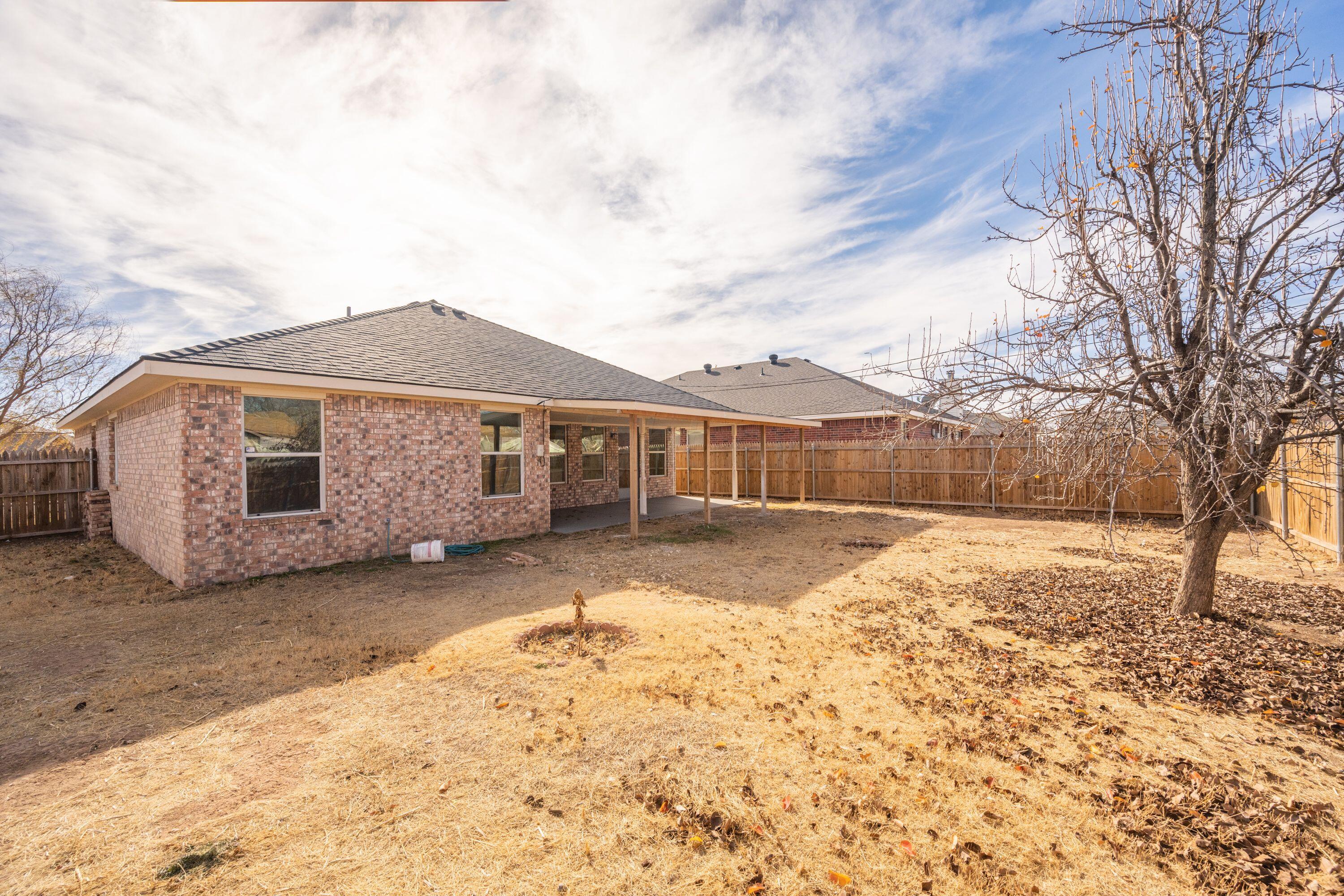4712 Capulin Lane Amarillo, TX 79110 - Photo 17 of 18 a front view of a house with a yard covered in snow