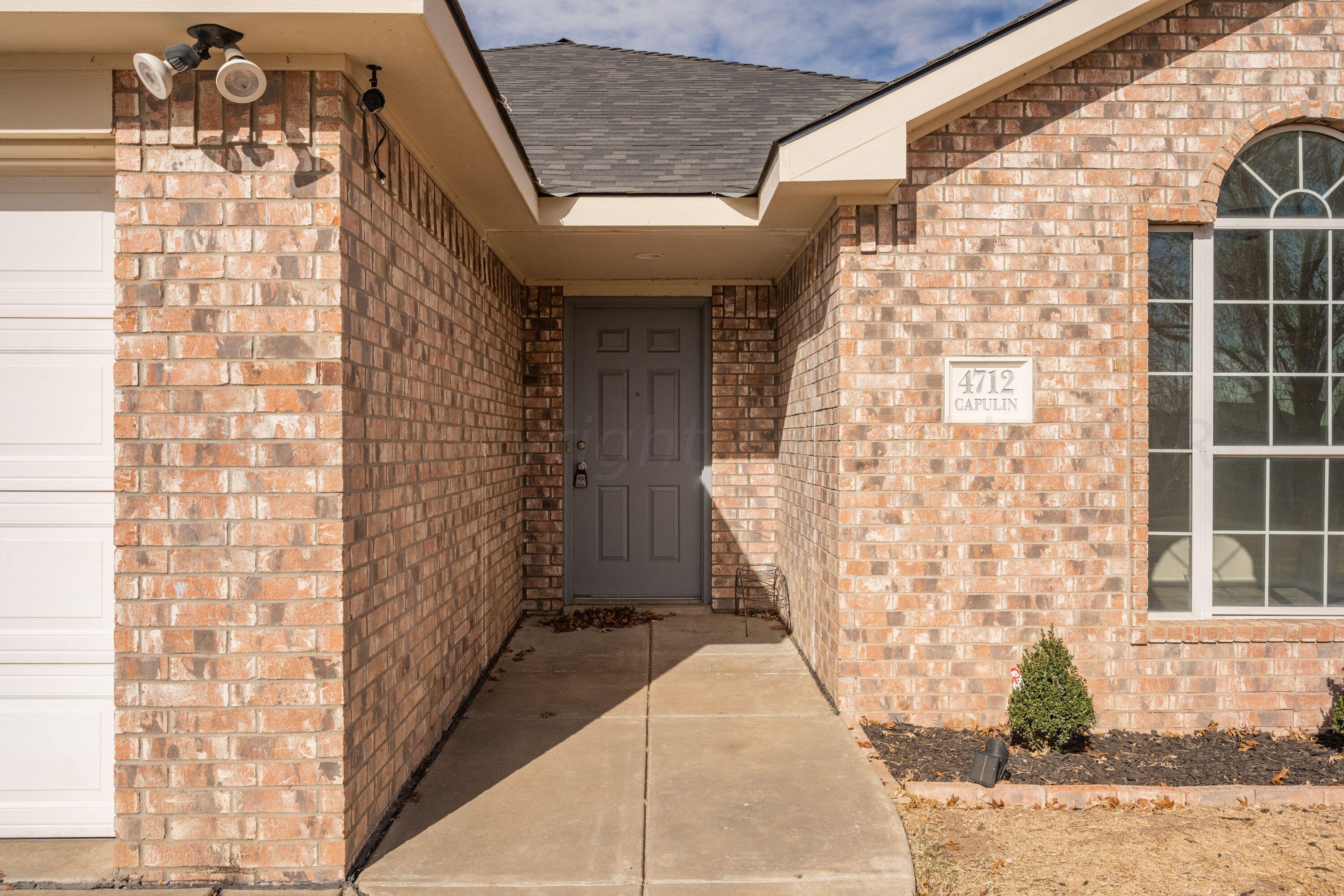 4712 Capulin Lane Amarillo, TX 79110 - Photo 2 of 18 a view of a brick house with a street