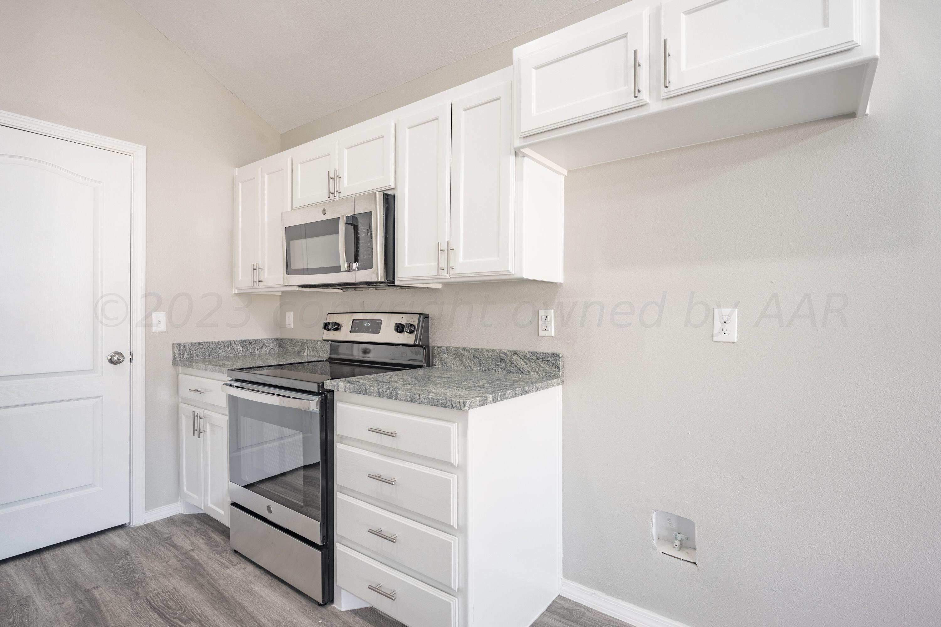 4712 Capulin Lane Amarillo, TX 79110 - Photo 3 of 18 a kitchen with granite countertop cabinets stainless steel appliances and a counter space