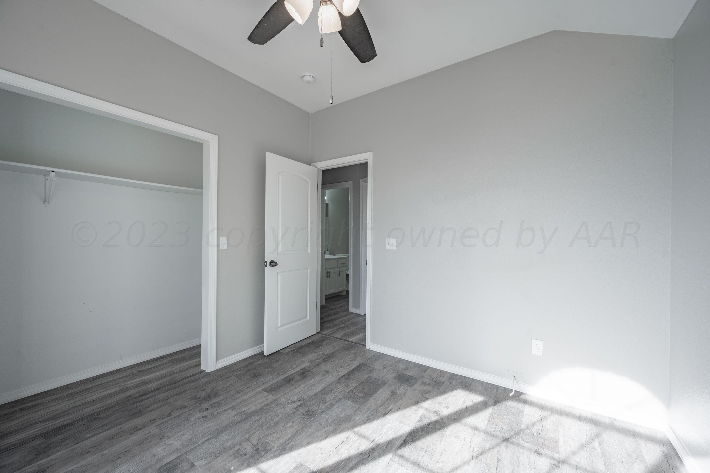 4712 Capulin Lane Amarillo, TX 79110 - Photo 8 of 18 wooden floor in an empty room