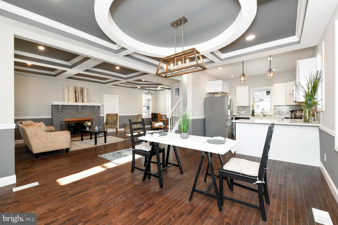 3815 Chatham Road Baltimore, MD 21215 - Photo 1 of 28 a dining room with furniture a fireplace and wooden floor