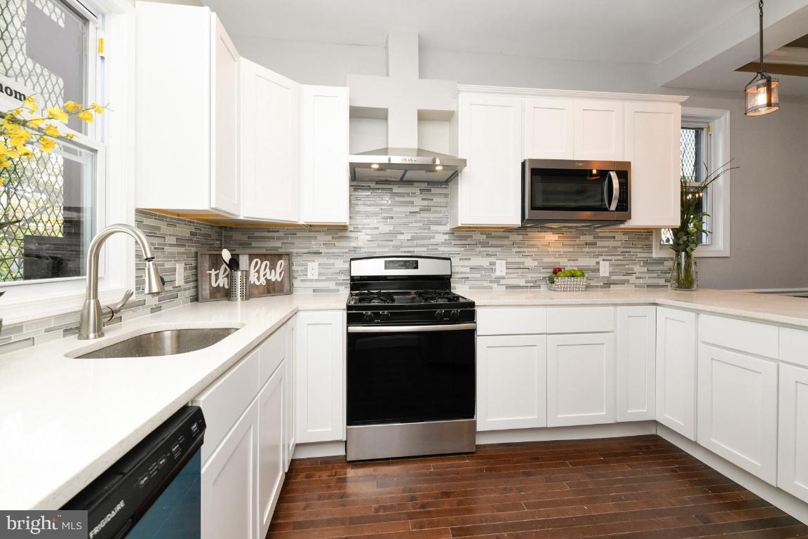 3815 Chatham Road Baltimore, MD 21215 - Photo 17 of 28 a kitchen with stainless steel appliances granite countertop a sink and a stove