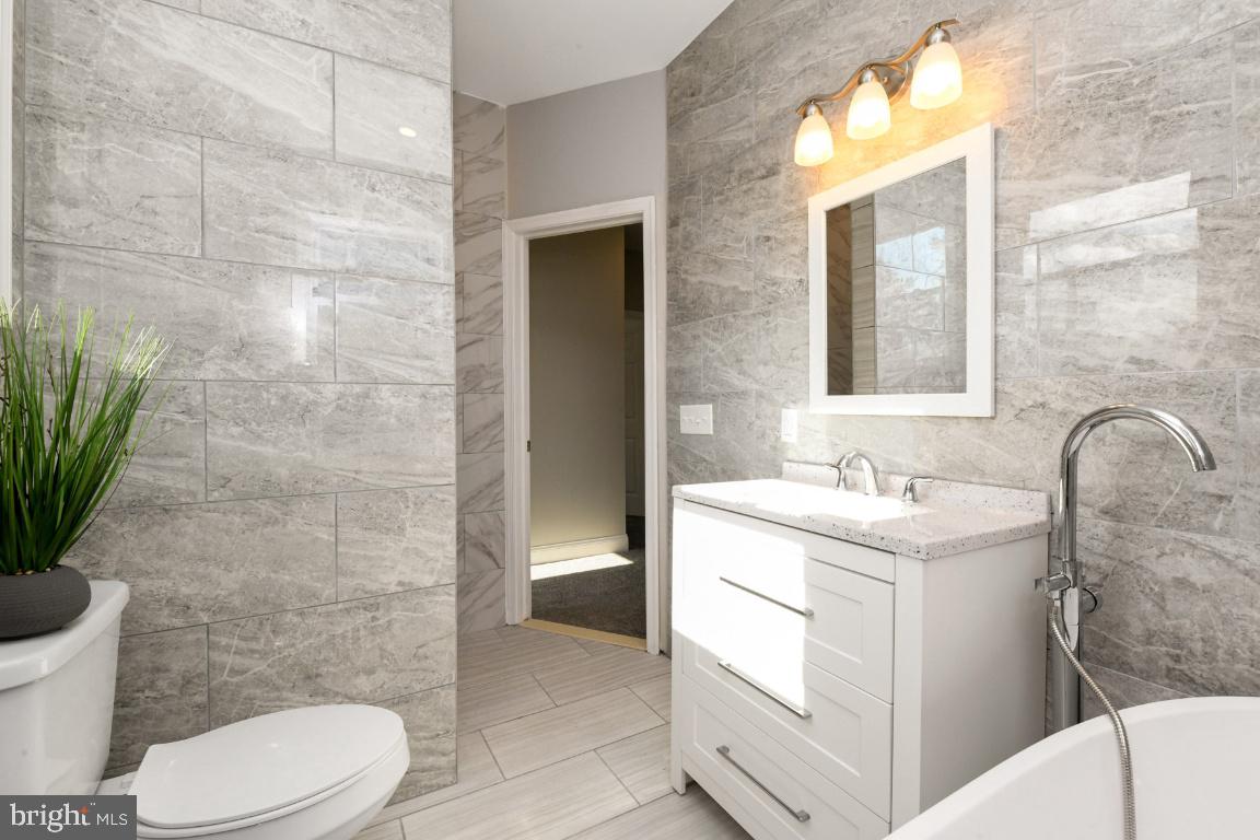 3815 Chatham Road Baltimore, MD 21215 - Photo 20 of 28 a bathroom with a toilet sink and mirror