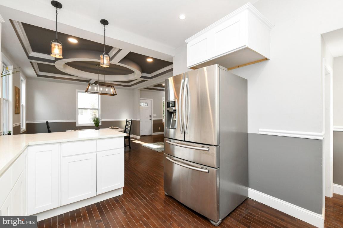 3815 Chatham Road Baltimore, MD 21215 - Photo 6 of 28 a kitchen with stainless steel appliances a refrigerator and a hard wood floor