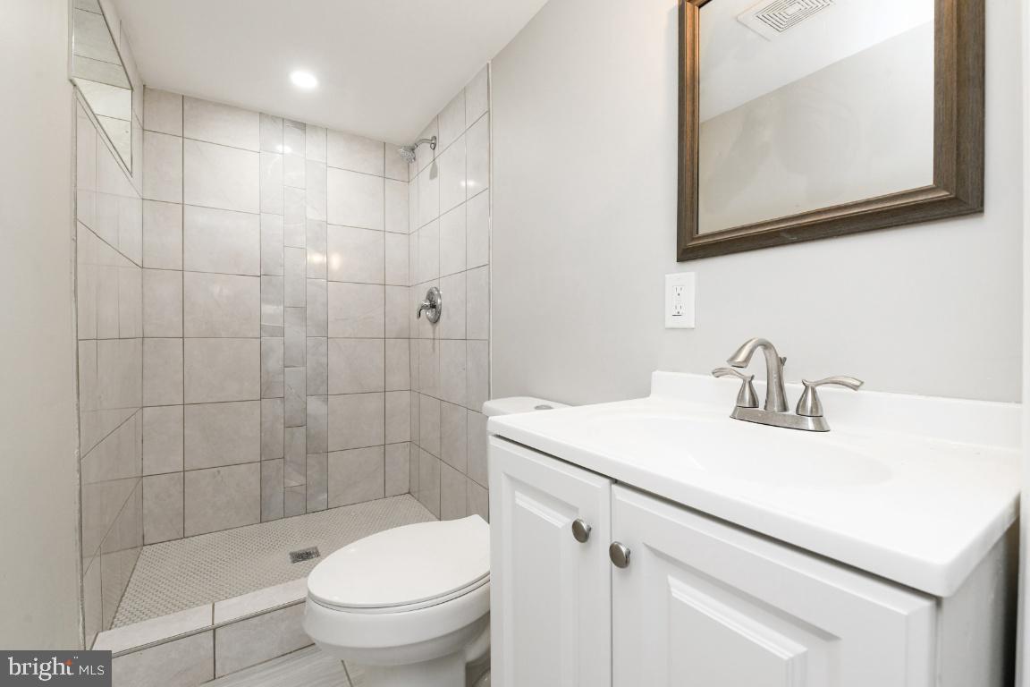 3815 Chatham Road Baltimore, MD 21215 - Photo 7 of 28 a bathroom with a sink a toilet and a mirror
